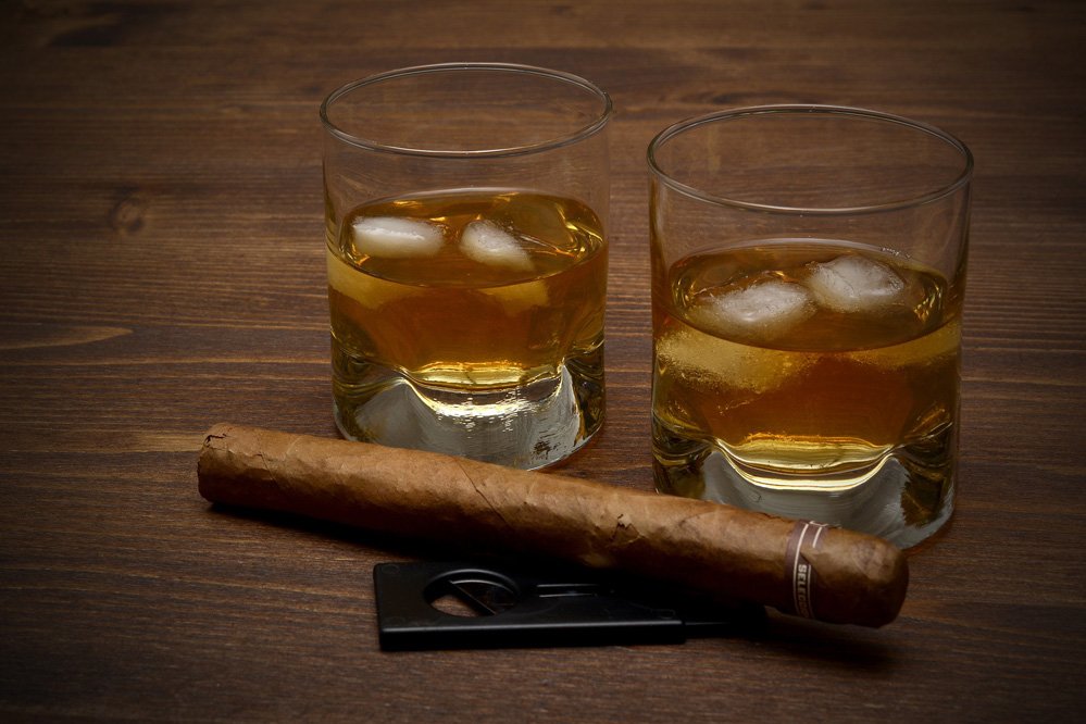 two glasses of whisky and a cigar